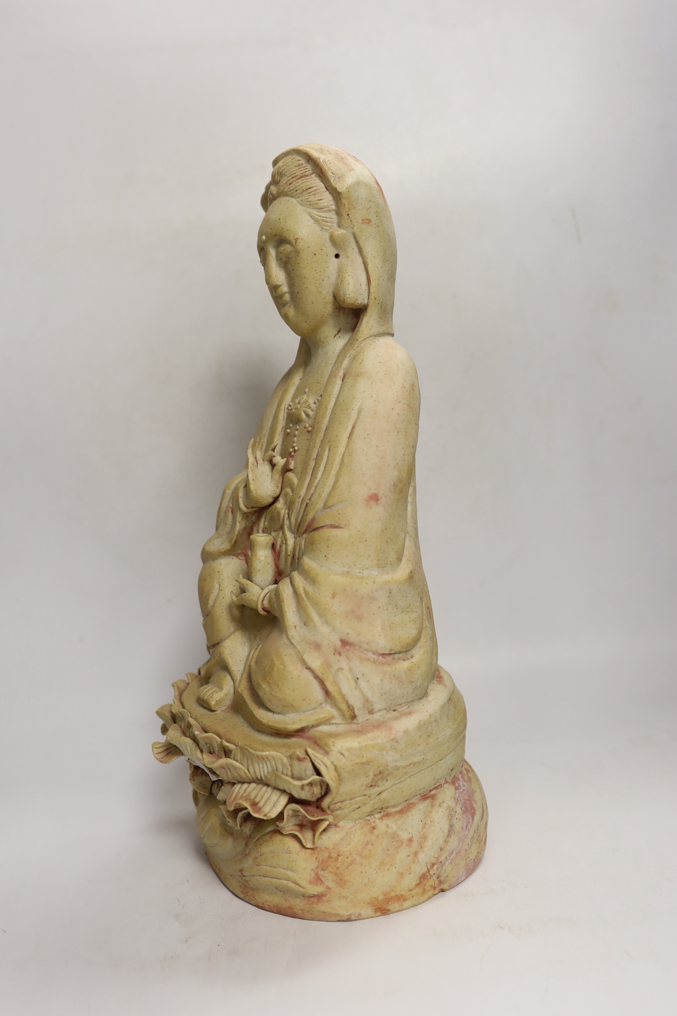 A Chinese biscuit figure of Guanyin, 38cm high